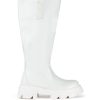 white faux leather chunky knee high boots with a flared style and chunky sole